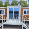 Prefabricated three-in-one foldable and expandable double-wing container house