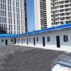 Blue four-slope roof T-shaped prefabricated house