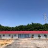 Red four-slope roof T-shaped prefabricated house