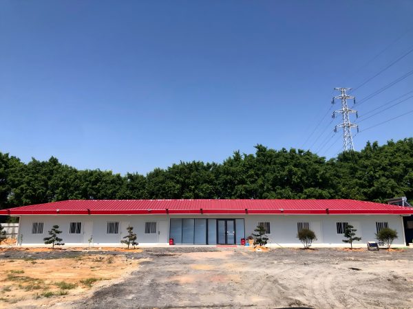 Red four-slope roof T-shaped prefabricated house