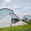 Dark gray quadrangle-style traditional T-shaped prefabricated house