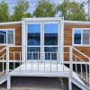 Prefabricated three-in-one foldable and expandable double-wing container house
