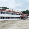 Red four-slope roof T-shaped prefabricated house