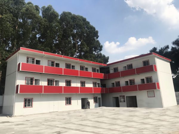 Red four-slope roof T-shaped prefabricated house
