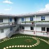 Dark gray quadrangle-style traditional T-shaped prefabricated house