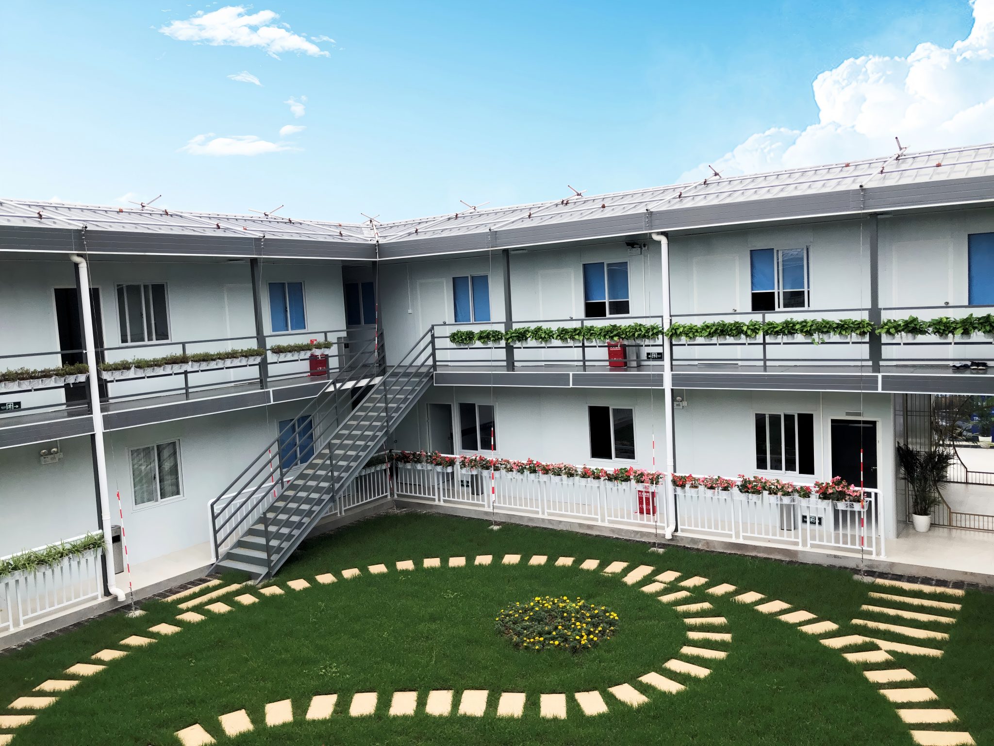 Dark gray quadrangle-style traditional T-shaped prefabricated house
