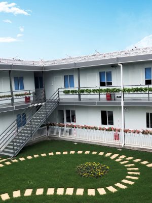 Dark gray quadrangle-style traditional T-shaped prefabricated house