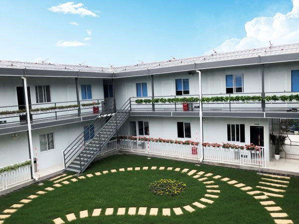 Dark gray quadrangle-style traditional T-shaped prefabricated house