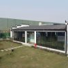 Dark gray quadrangle-style traditional T-shaped prefabricated house