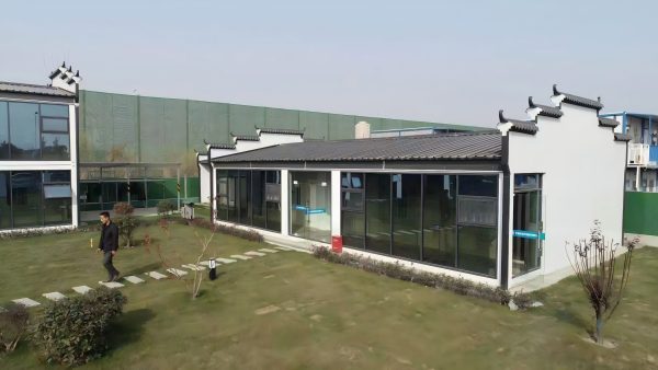 Dark gray quadrangle-style traditional T-shaped prefabricated house