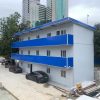 Blue four-slope roof T-shaped prefabricated house
