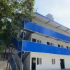 Blue four-slope roof T-shaped prefabricated house