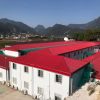 Red four-slope roof T-shaped prefabricated house