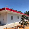 Red four-slope roof T-shaped prefabricated house