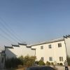 Dark gray quadrangle-style traditional T-shaped prefabricated house