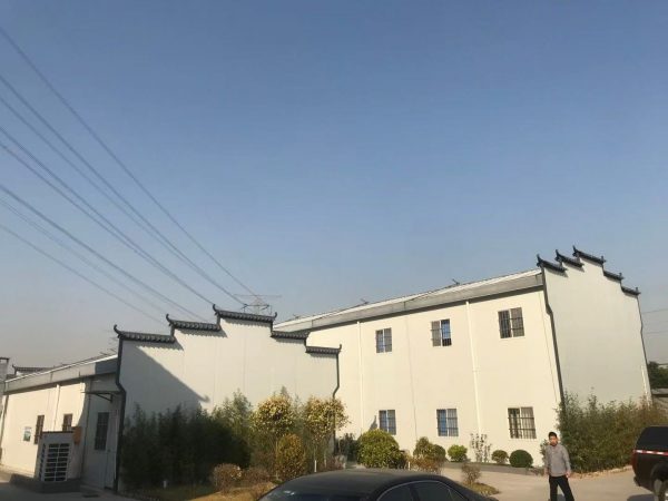 Dark gray quadrangle-style traditional T-shaped prefabricated house