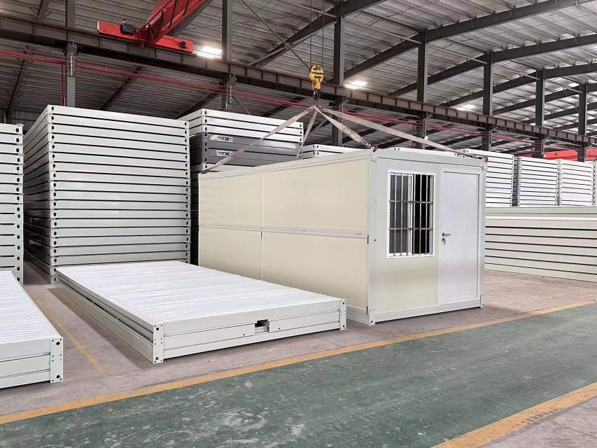 Flat packed Z folding container houses stacked inside factory for efficient transportation